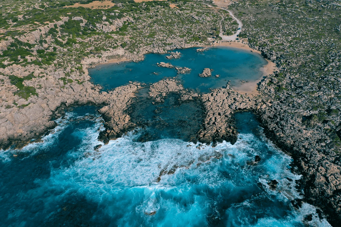 Aerial view of the rock pools at Aspri Limni (White Lake) beach, Crete