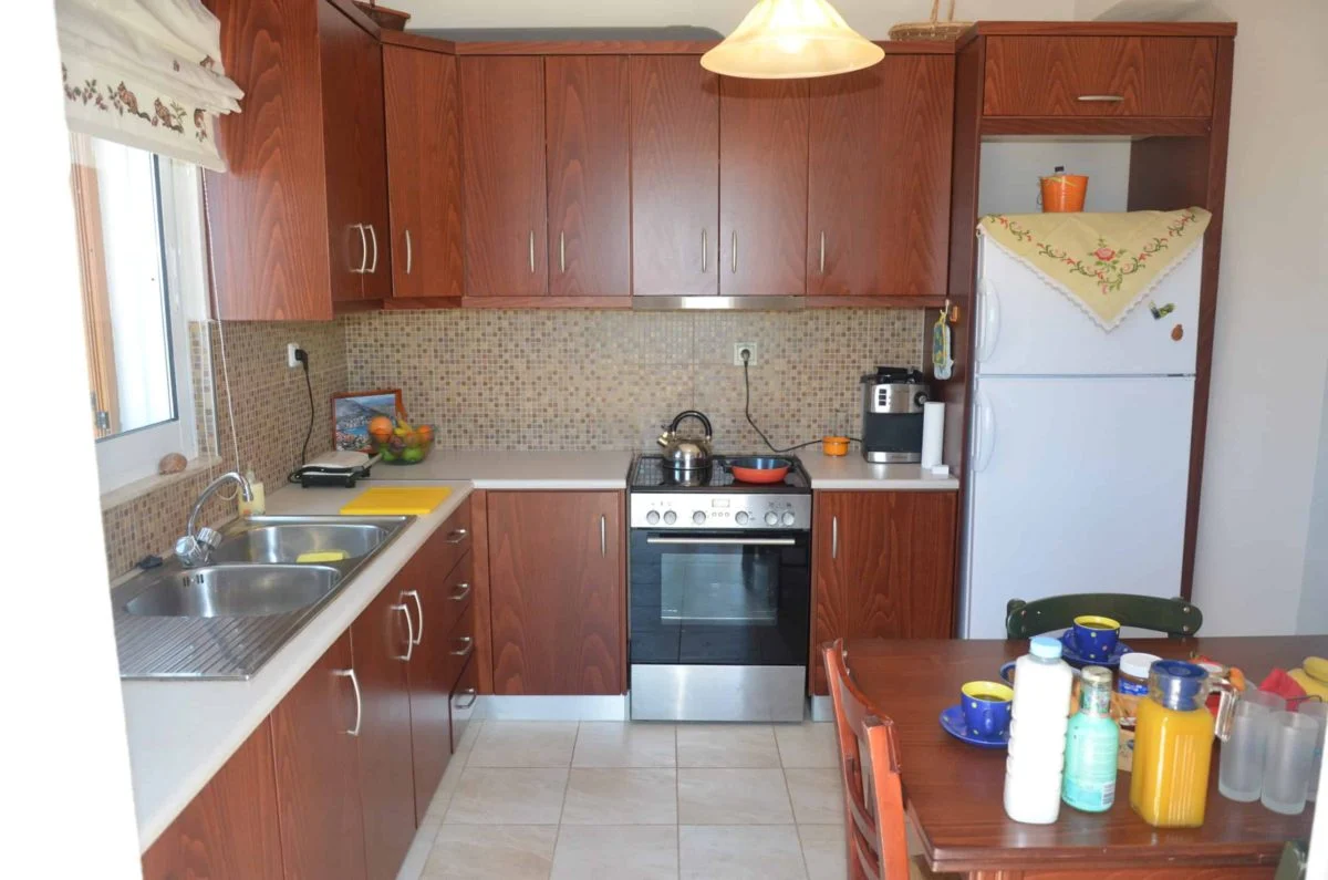Villa Ciel kitchen wooden cabinetry stove refrigerator detail